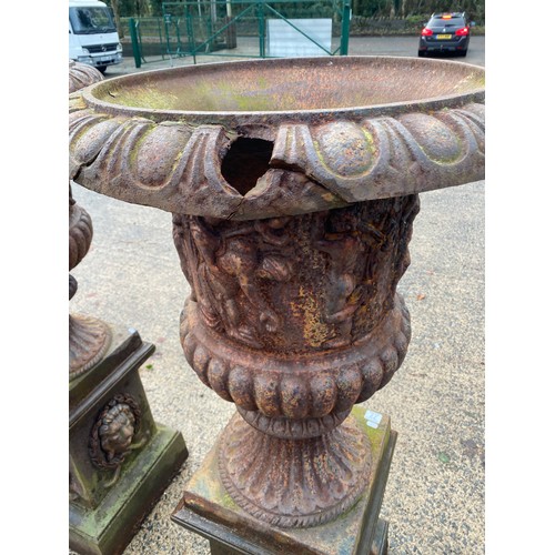 77 - PAIR OF DECORATIVE CAST IRON PLANTERS ON PLINTHS APPROX 5ft HIGH - SLIGHT DAMAGE AS SHOWN