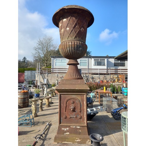 144 - LARGE ANTIQUE CAST IRON URN ON BASE WITH LION MASK DETAIL - APPROX  14 FT TALL - SMALL PIECE DAMAGED... 