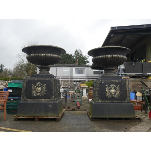 94 - PAIR OF LARGE CONCRETE PLANTERS ON CAST IRON BASES - BASE IS 4 ft x 4 ft - HEIGHT APPROX 8.1/2 ft