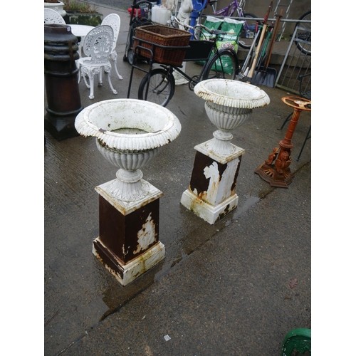 131 - PAIR OF CAST IRON URNS ON STANDS - SOME DAMAGE