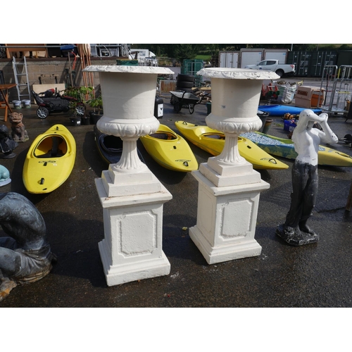 98 - 2 LARGE CAST IRON URNS ON CONCRETE BASES