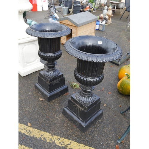 75 - PAIR OF BLACK CAST IRON URNS ON BASES