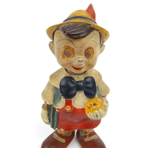 557 - Hand painted clockwork composite dancing Pinocchio toy, 20cm high