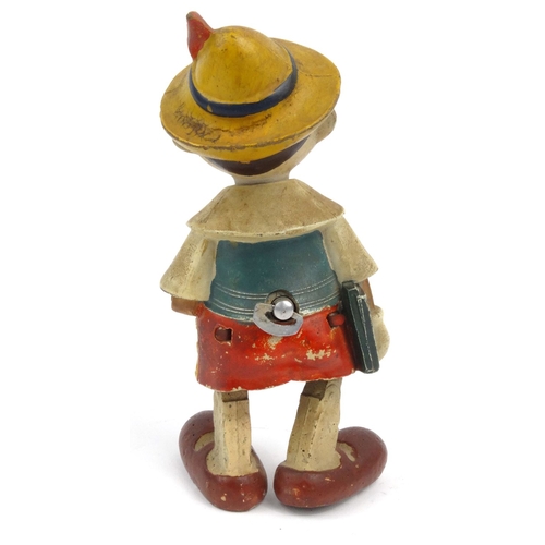 557 - Hand painted clockwork composite dancing Pinocchio toy, 20cm high