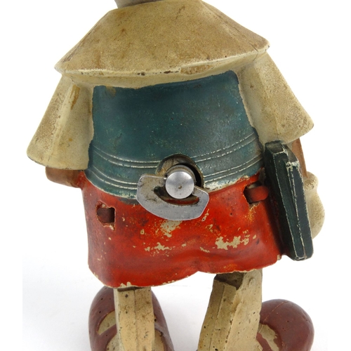 557 - Hand painted clockwork composite dancing Pinocchio toy, 20cm high