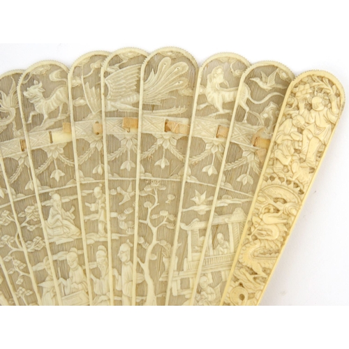 587 - Oriental Chinese pierced ivory fan pierced decorated with figures, dragons and landscape, 19cm long