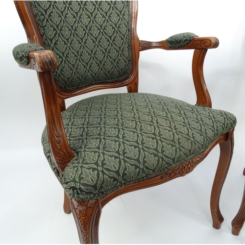 4 - Pair of carved mahogany elbow chairs with green floral upholstery