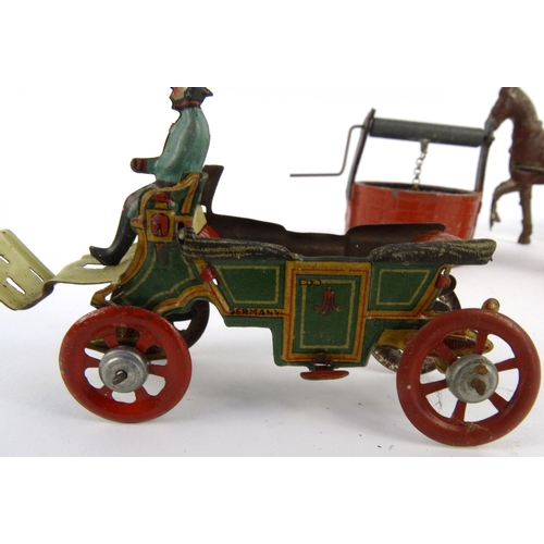 552 - Assorted tinplate and die cast toys including birdcage, horsedrawn wagon and a wishing well, the lar... 