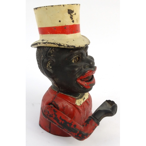 573 - Jolly nigger cast iron trick moneybox wearing a top hat, 22cm high