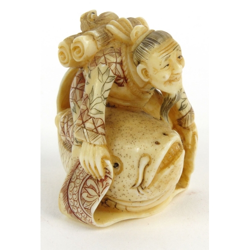 589 - Oriental Japanese ivory Netsuke in the form of an elderly man riding a carp, signature mark to base,... 