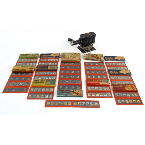 564 - Child's tinplate Magic Lantern with assorted Mickey Mouse, Snow White and the Seven Dwarves, Three L... 