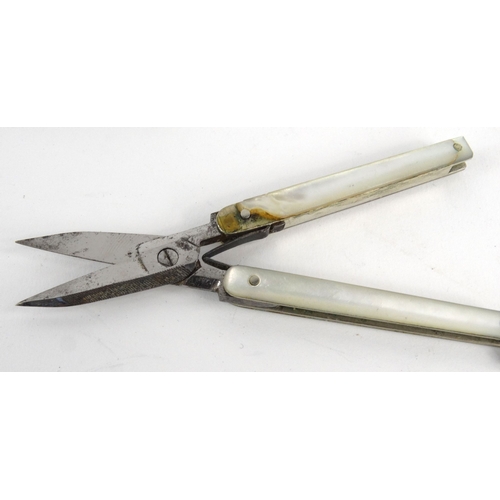117 - Five silver and mother of pearl fruit knives, silver cased pocket knife and a pair of folding mother... 