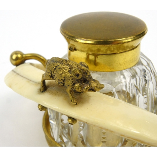 112 - Ivory Warthog tusk brass and cut glass inkwell, 11cm wide