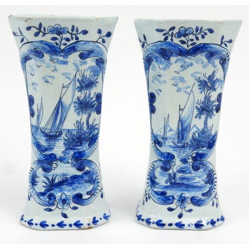 733 - Pair of Dutch Delft pottery vases hand painted with panels sailing boats and flowers, 14.5cm high