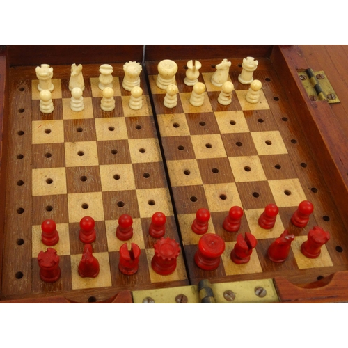 570 - Mahogany folding travelling boxed chess set, 18cm square