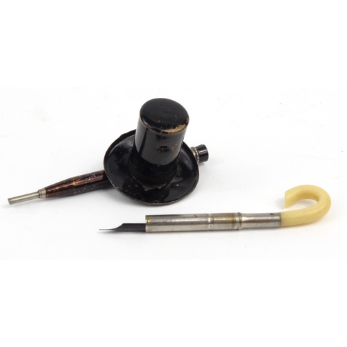 109 - Novelty inkwell with dip pen in the form of a top hat and umbrella, 11cm diameter
