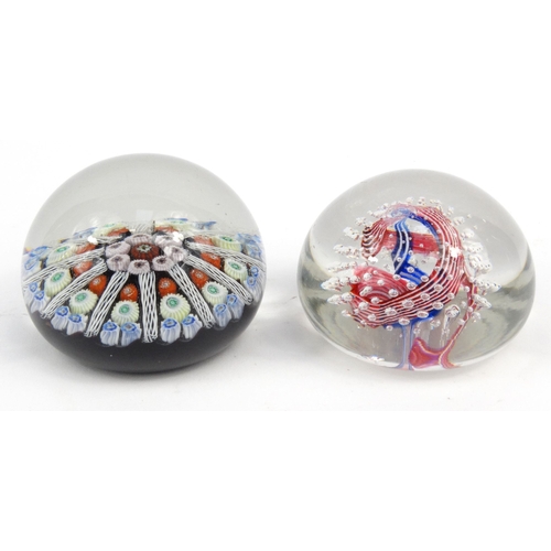 761 - Two glass paperweights - one with colourful glass canes, the larger 7cm diameter