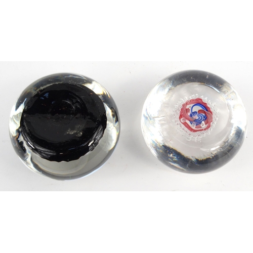 761 - Two glass paperweights - one with colourful glass canes, the larger 7cm diameter