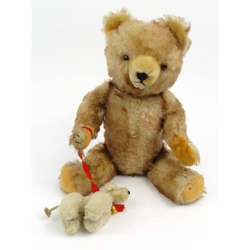 534 - Vintage Hermann straw filled teddy bear with jointed limbs and original poodle attached, 40cm high