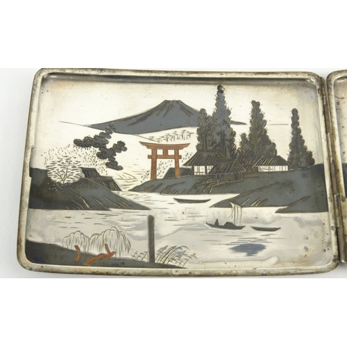 584 - Oriental Japanese sterling silver cigarette case decorated with landscape scenes, 11cm diameter