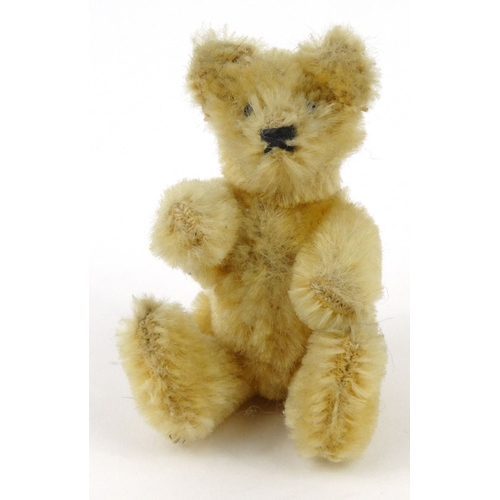 539 - Miniature straw filled teddy bear with beaded glass eyes, 19cm high