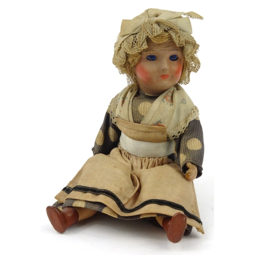 558 - Continental composite child's doll with bonnet, 20cm high