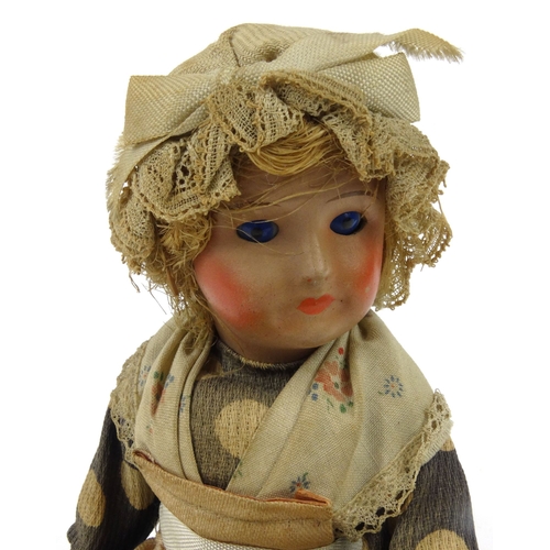 558 - Continental composite child's doll with bonnet, 20cm high