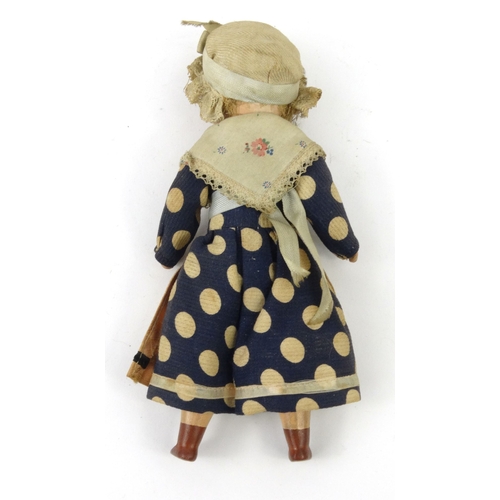 558 - Continental composite child's doll with bonnet, 20cm high