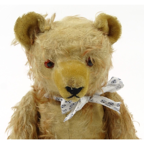 536 - Old straw filled teddy bear with beaded glass eyes, 42cm high