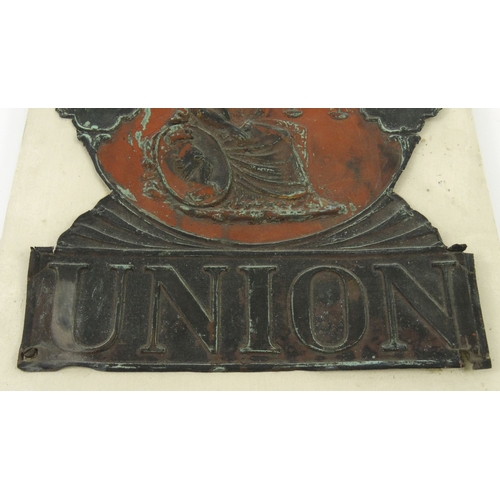 49 - Tin Norwich Union Insurance fire plaque mounted on a wooden board, 27cm x 22cm