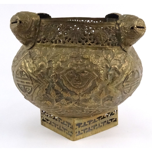 579 - Large oriental pierced brass pot with dragon finials and masks, 29cm high