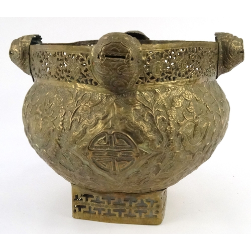 579 - Large oriental pierced brass pot with dragon finials and masks, 29cm high