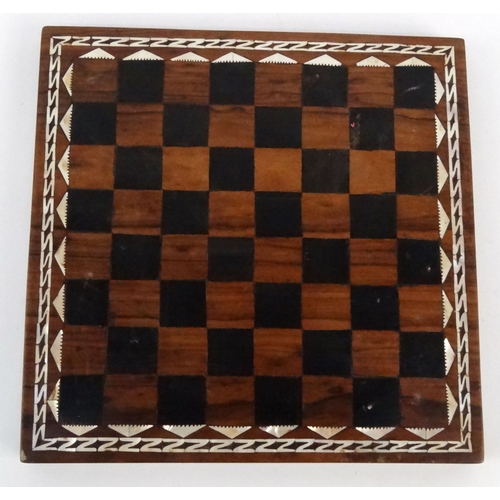 571 - Hardwood mother of pearl inlaid chess board with carved horn chess pieces, the largest piece 8cm hig... 