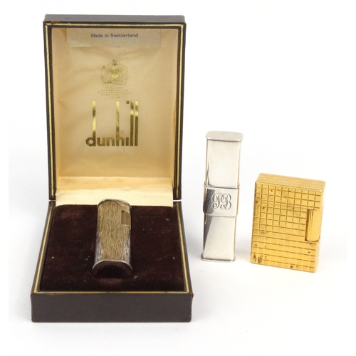 122 - Three lighters comprising boxed Dunhill bark design lighter, silver coloured example and a Dupont ex... 