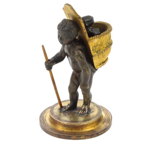 110 - Victorian smoking interest bronze vesta of a boy carrying a monkey pipe tamper in a basket, stamped ... 