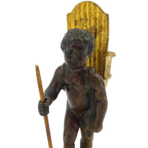 110 - Victorian smoking interest bronze vesta of a boy carrying a monkey pipe tamper in a basket, stamped ... 