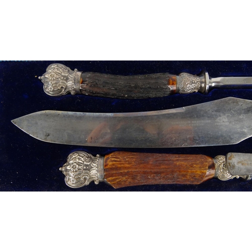 39 - Levesley Brothers Sheffield horn handled carving set with silver finials, Sheffiedl 1897-98, in a fi... 