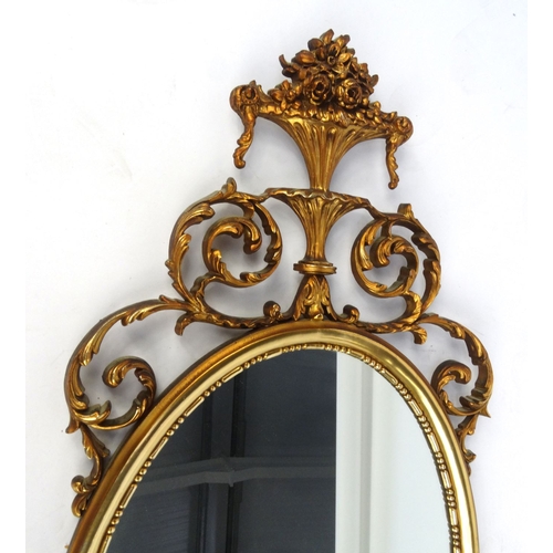 50 - Oval Ornate gilt framed mirror, 61cm x 41cm