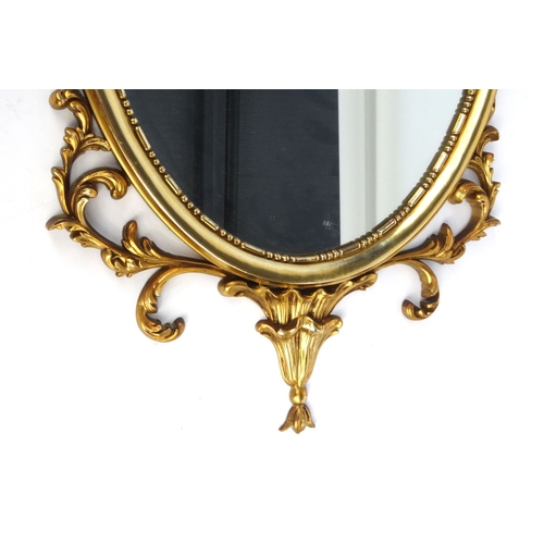 50 - Oval Ornate gilt framed mirror, 61cm x 41cm