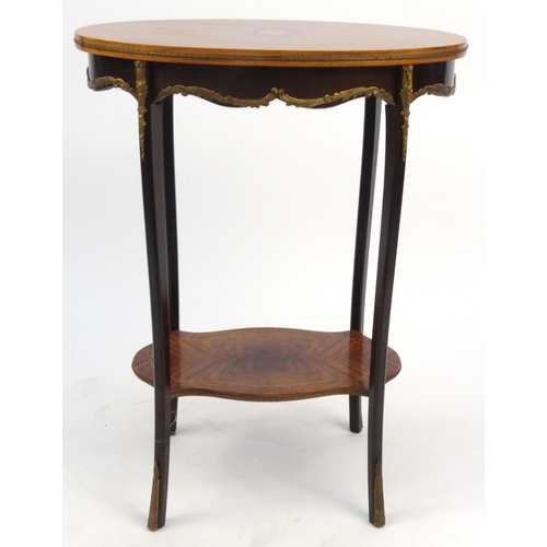 25 - Oval walnut occasional table with floral inlaid top and gilt brass mounts, 74cm high