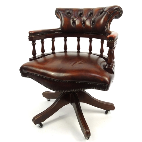 24 - Brown leather captain's chair with buttonback upholstered back