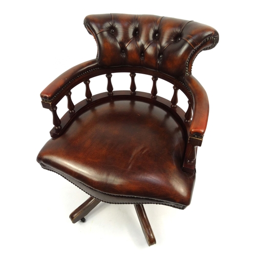 24 - Brown leather captain's chair with buttonback upholstered back