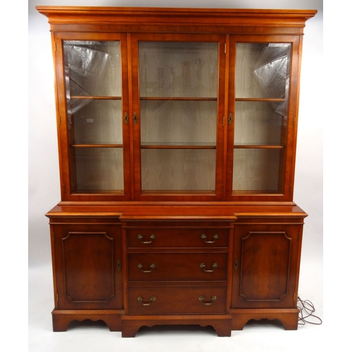 56 - Yew wood wall unit fitted with glazed doors above cupboard doors and drawers, 190cm high x 150cm wid... 
