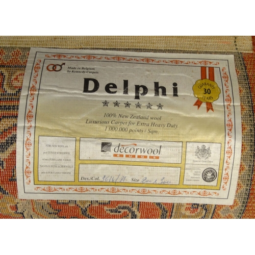 44 - Delphi red geometric patterned wool rug, approximately 300cm x 200cm