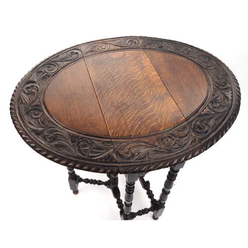 47 - Carved Oval oak gateleg table, 72cm high x 86cm wide x 68cm deep