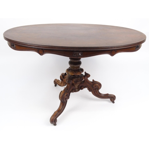 42 - Oval rosewood centre table with carved base, 76cm high x 125cm wide x 88cm deep