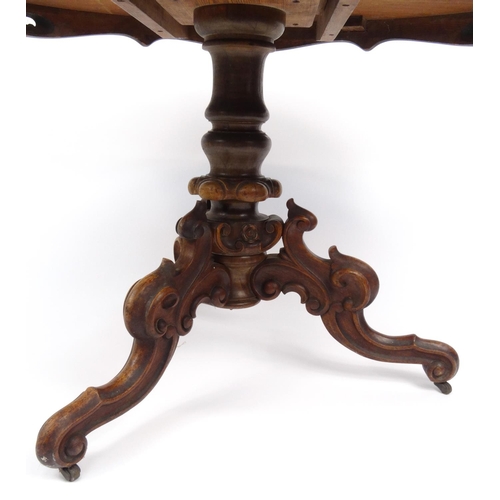 42 - Oval rosewood centre table with carved base, 76cm high x 125cm wide x 88cm deep