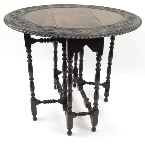 47 - Carved Oval oak gateleg table, 72cm high x 86cm wide x 68cm deep