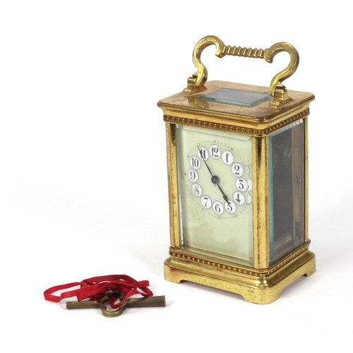 1303 - Brass carriage clock with enamel dial, 11cm high excluding the handle