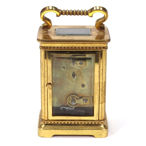 1303 - Brass carriage clock with enamel dial, 11cm high excluding the handle